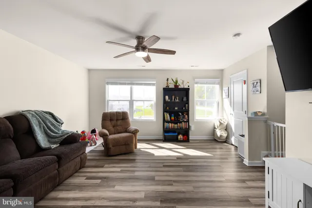 a living room with furniture window and a flat screen tv