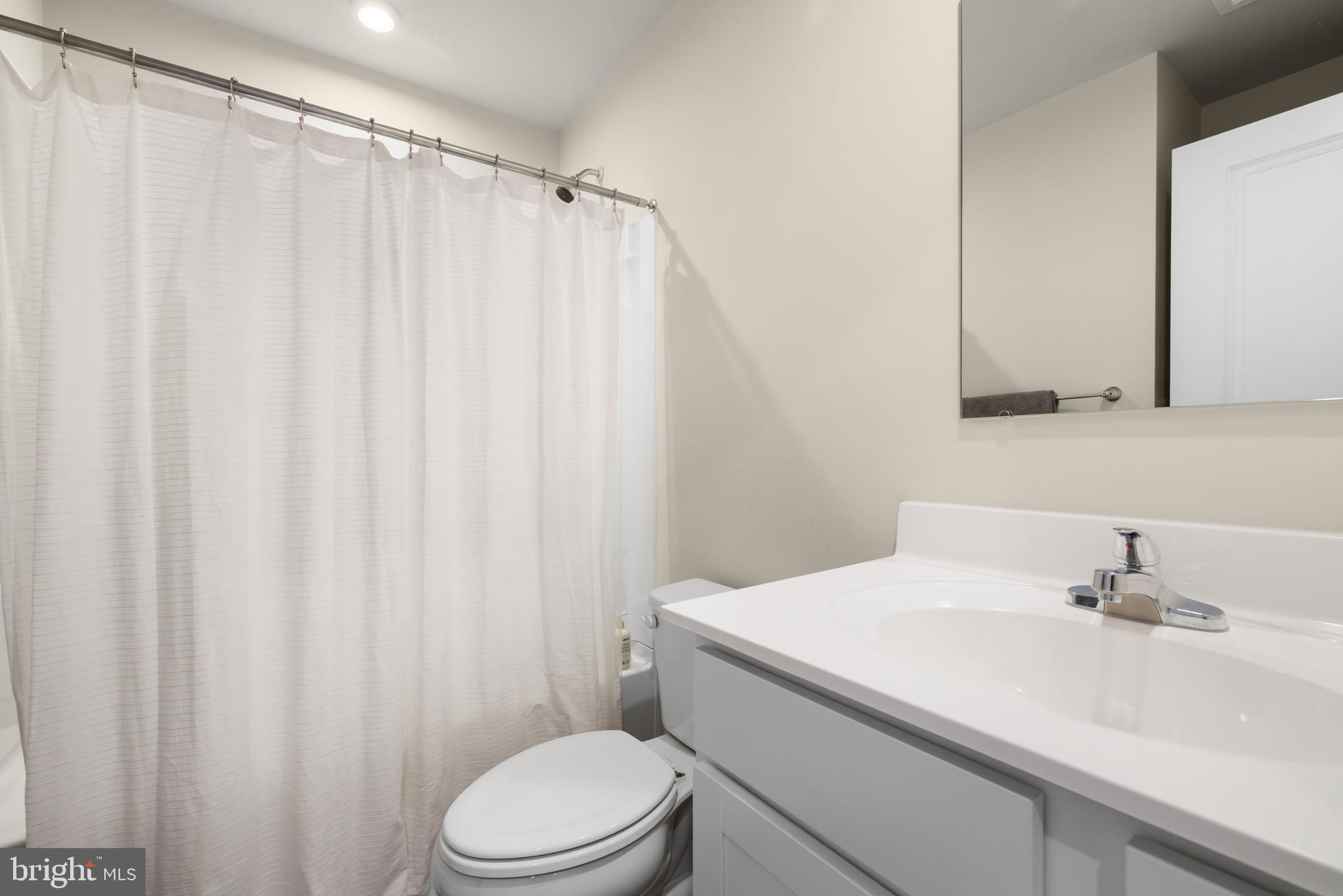 272 Rhea Drive Martinsburg, WV 25403 - Photo 22 of 27 a bathroom with a sink a toilet and shower curtain