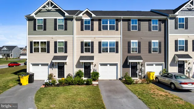 a front view of a residential apartment building with a yard