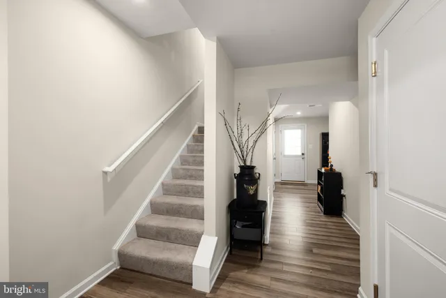 a view of entryway and hall with wooden floor