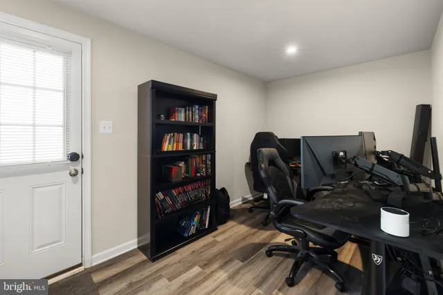 a view of a workspace with furniture and wooden floor