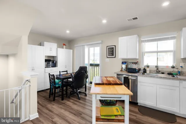 a kitchen that has a table and chairs in it