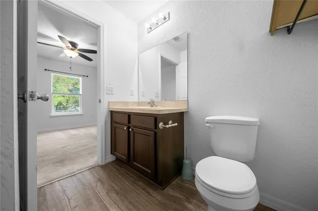 a bathroom with a toilet a sink and mirror