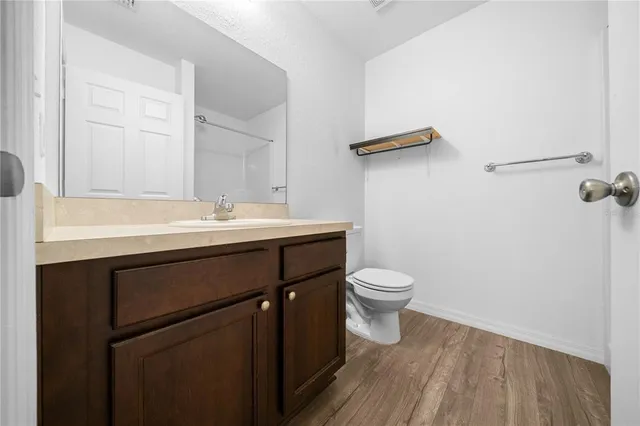 a bathroom with a sink a toilet a mirror and vanity