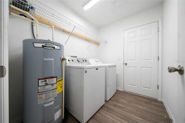 a utility room with cabinets washer and dryer