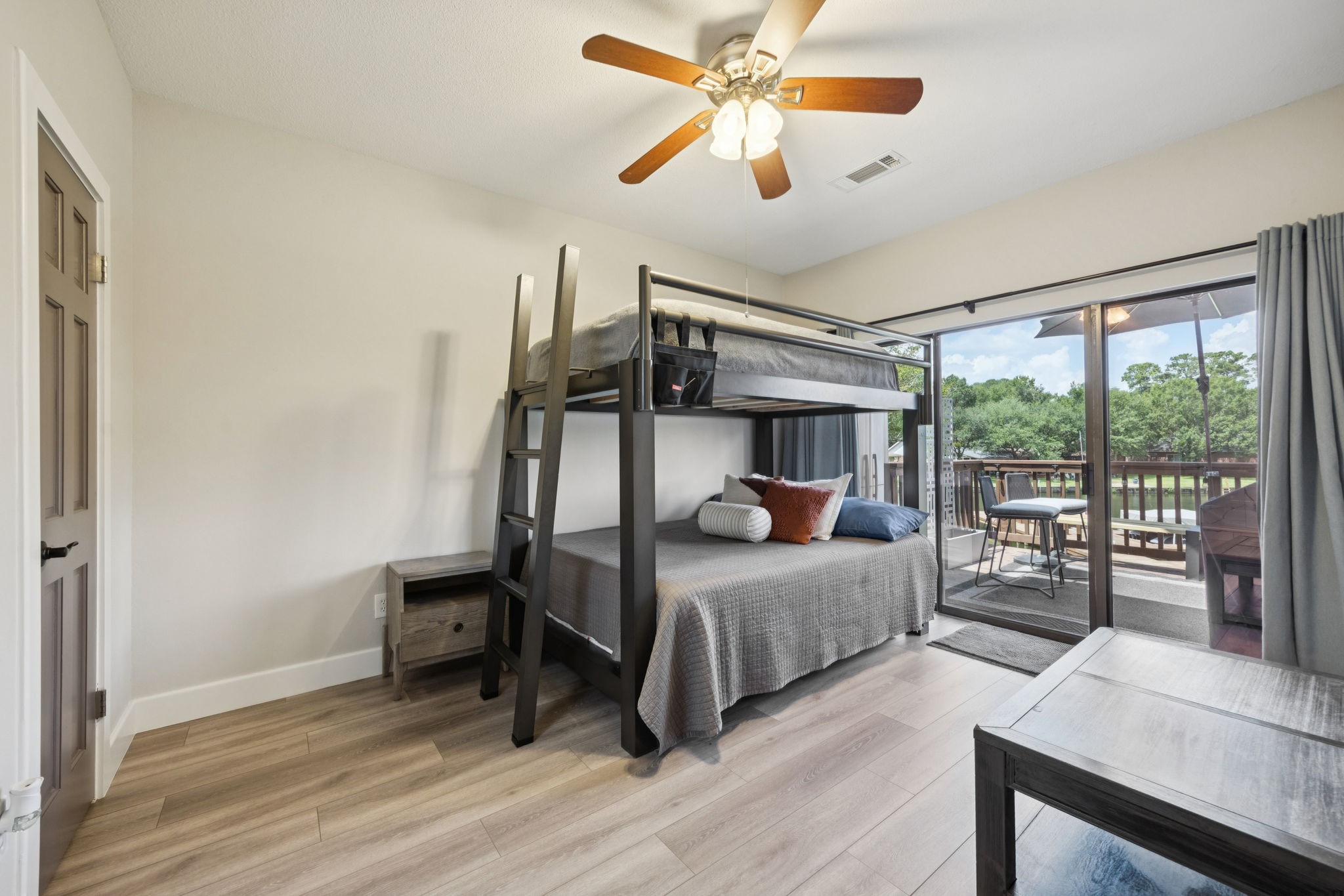 500 River Road, Unit 106 Montgomery, TX 77356 - Photo 16 of 32 Primary en suite with sliding doors offers direct patio access, stunning views to enjoy from inside, and large walk-in closet.