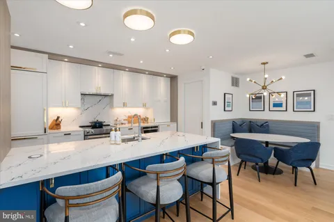 a kitchen with stainless steel appliances kitchen island granite countertop a sink and cabinets