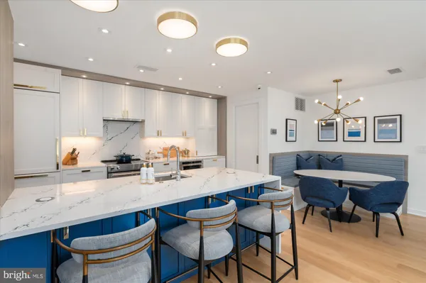 a kitchen with stainless steel appliances kitchen island granite countertop a sink and cabinets