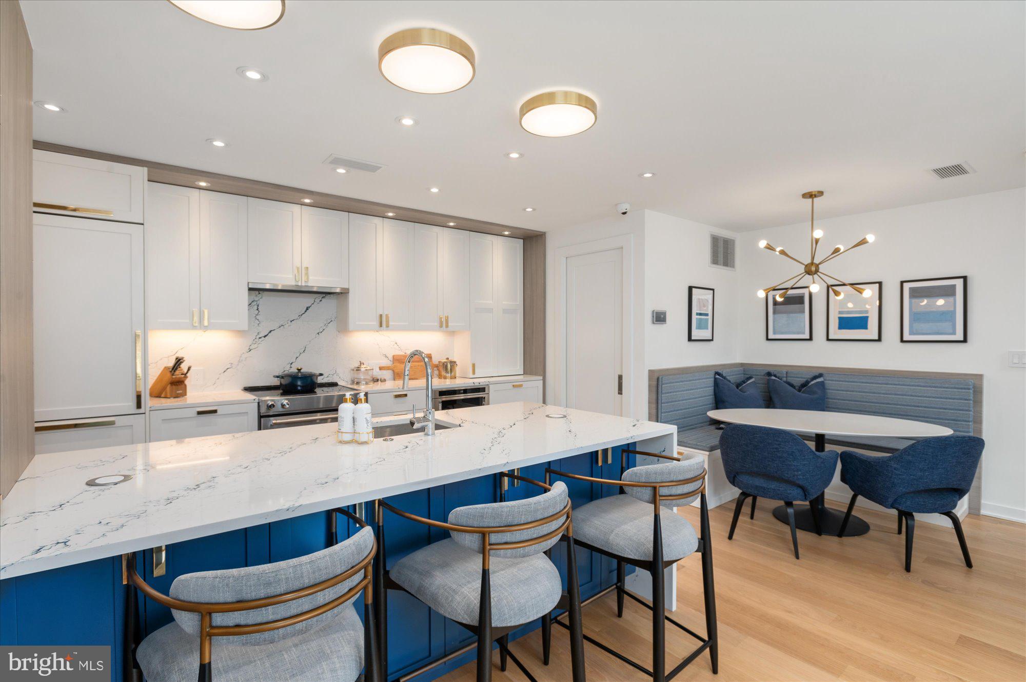 7313 Woodmont Avenue, Unit R Bethesda, MD 20814 - Photo 11 of 29 a kitchen with stainless steel appliances kitchen island granite countertop a sink and cabinets