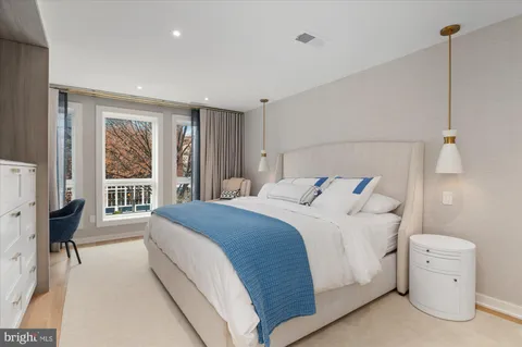 a bedroom with a bed and a large window