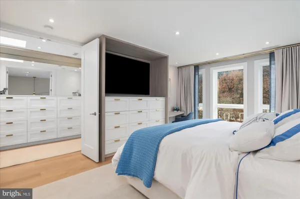 a bedroom with a large bed and a flat screen tv