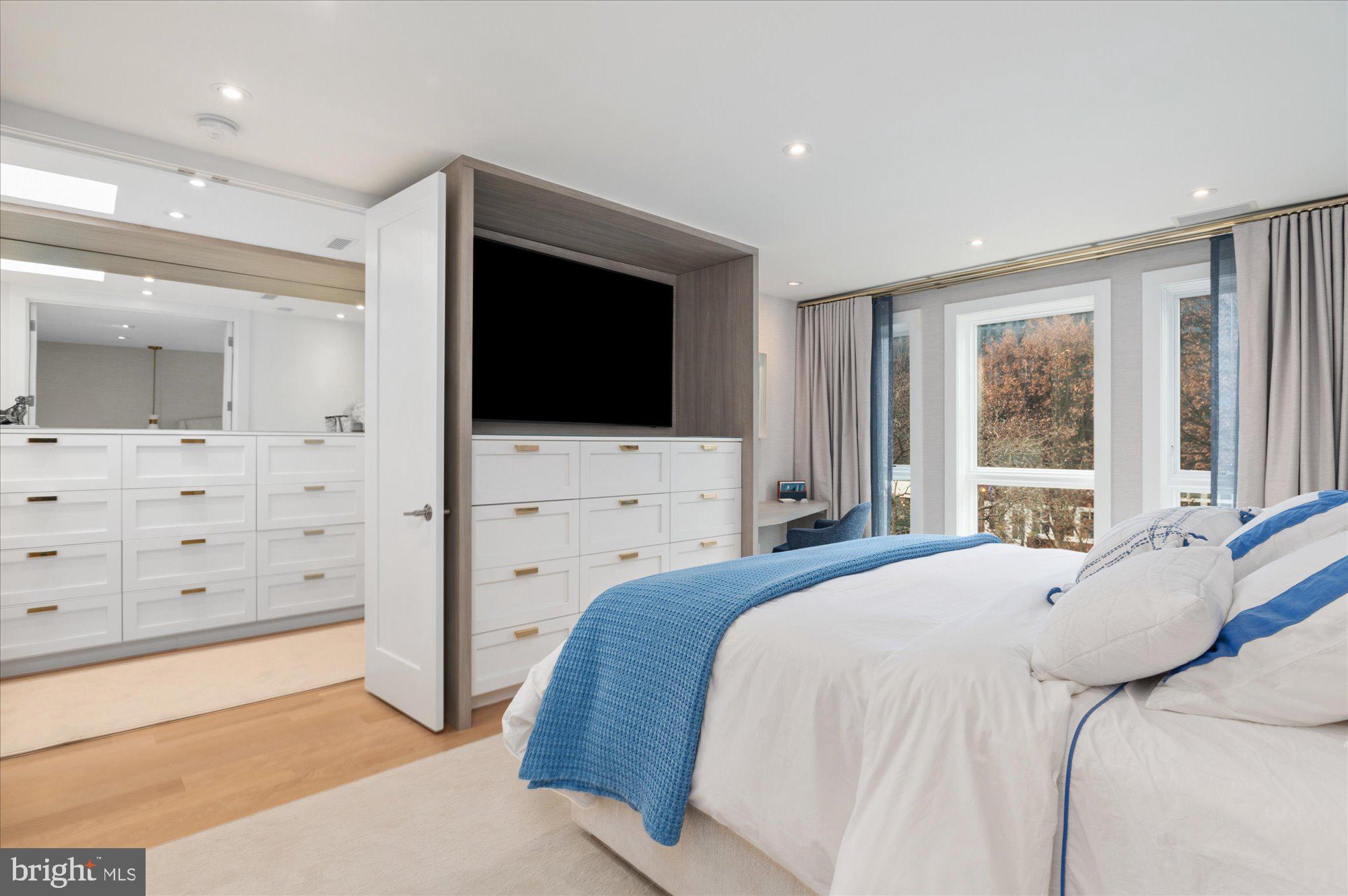 7313 Woodmont Avenue, Unit R Bethesda, MD 20814 - Photo 17 of 29 a bedroom with a large bed and a flat screen tv