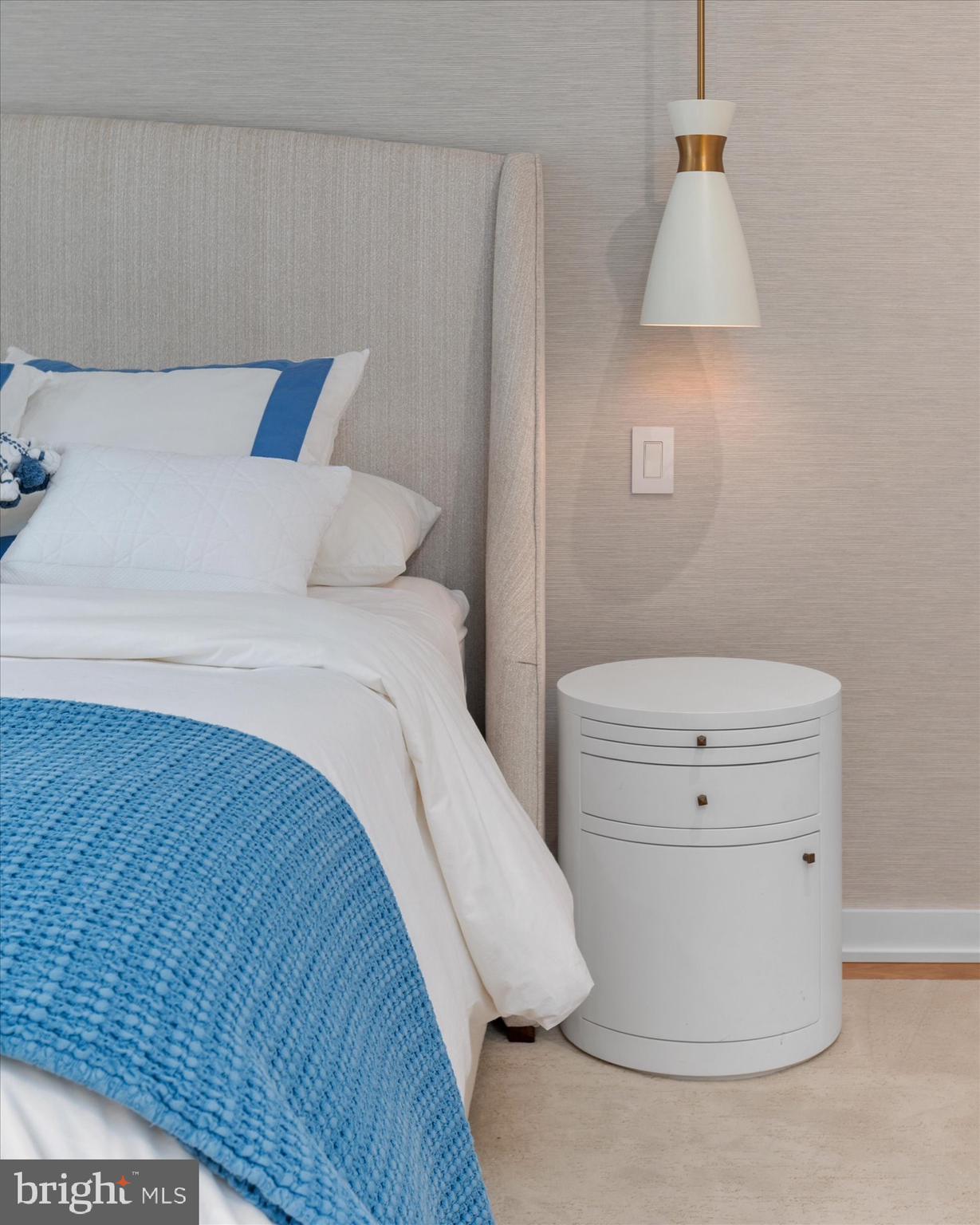 7313 Woodmont Avenue, Unit R Bethesda, MD 20814 - Photo 19 of 29 a bedroom with a bed and a lamp on the dresser