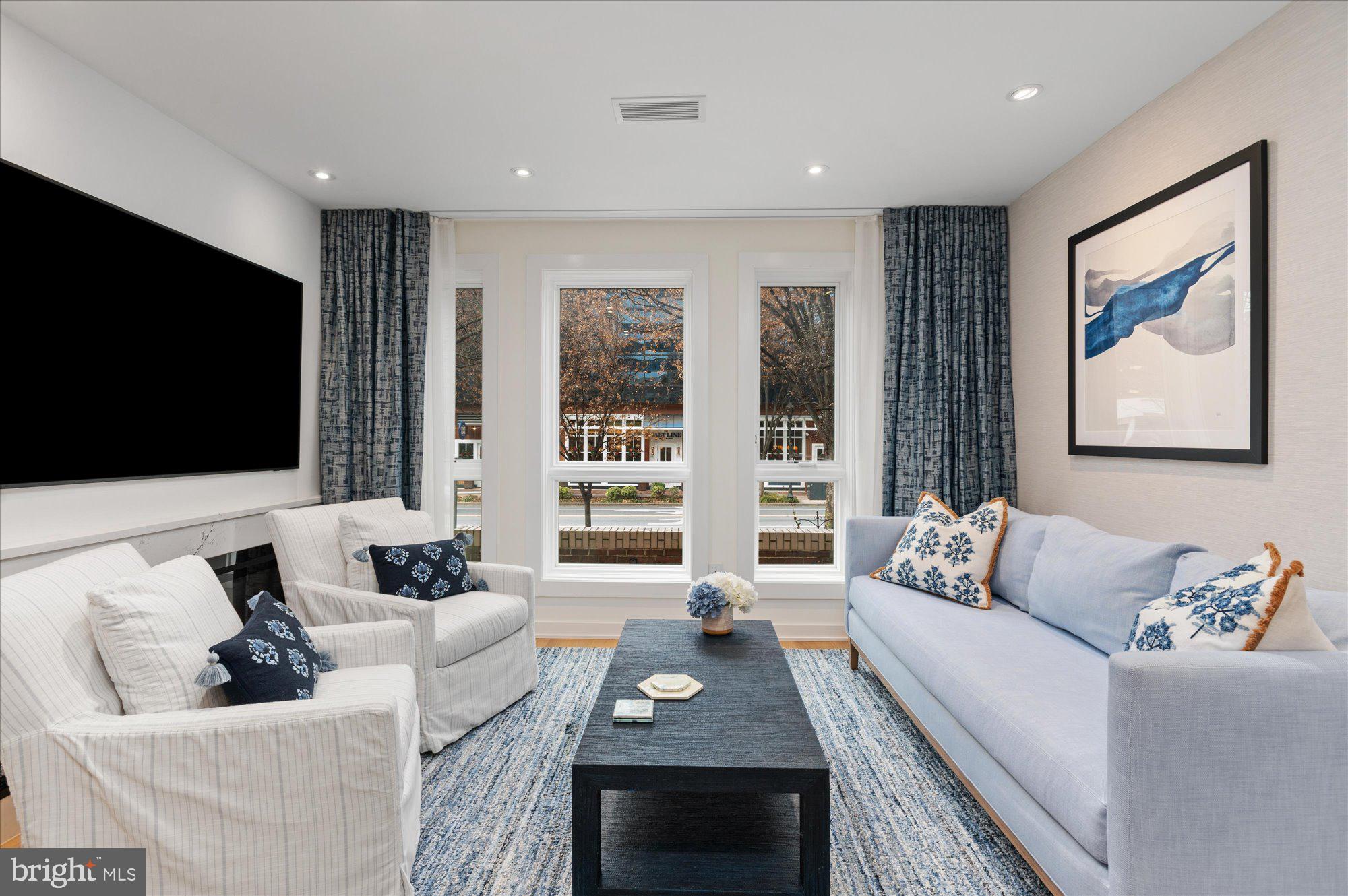 7313 Woodmont Avenue, Unit R Bethesda, MD 20814 - Photo 2 of 29 a living room with furniture and a flat screen tv