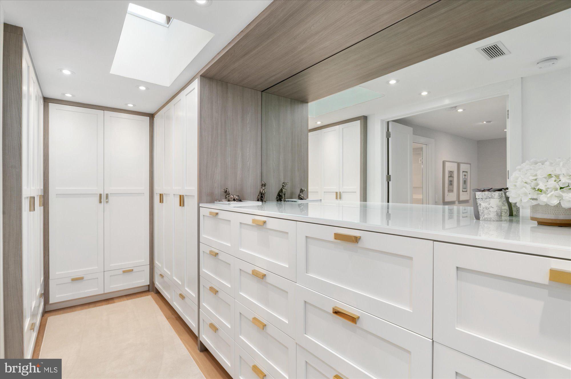 7313 Woodmont Avenue, Unit R Bethesda, MD 20814 - Photo 22 of 29 a bathroom with a sink mirror and vanity