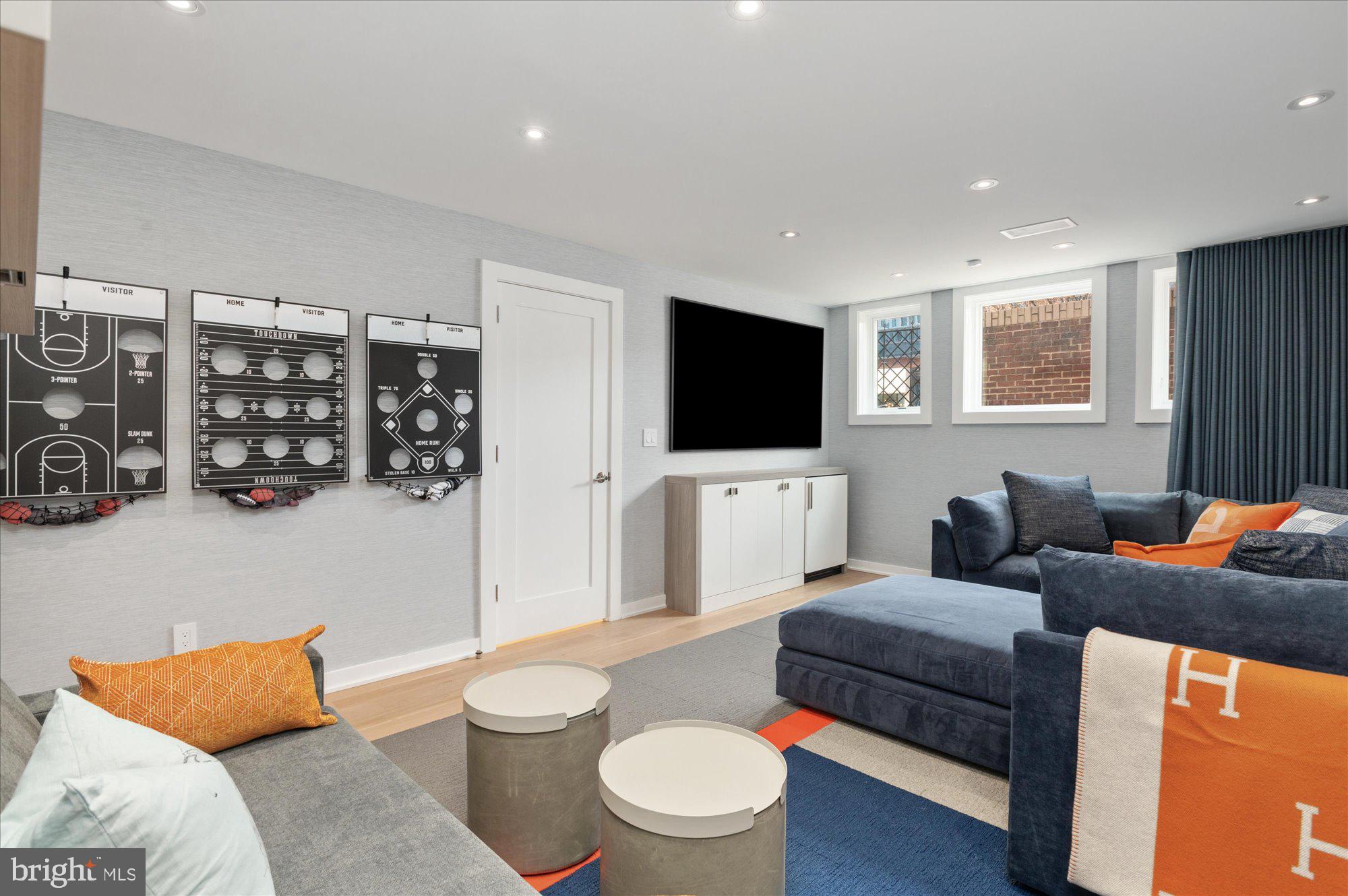 7313 Woodmont Avenue, Unit R Bethesda, MD 20814 - Photo 25 of 29 a living room with furniture and a flat screen tv