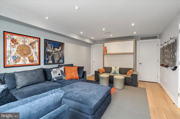 a living room with furniture a large window and a couch