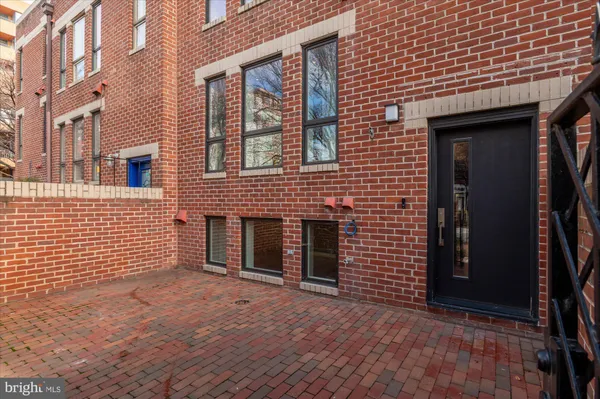 a view of a brick house with many windows