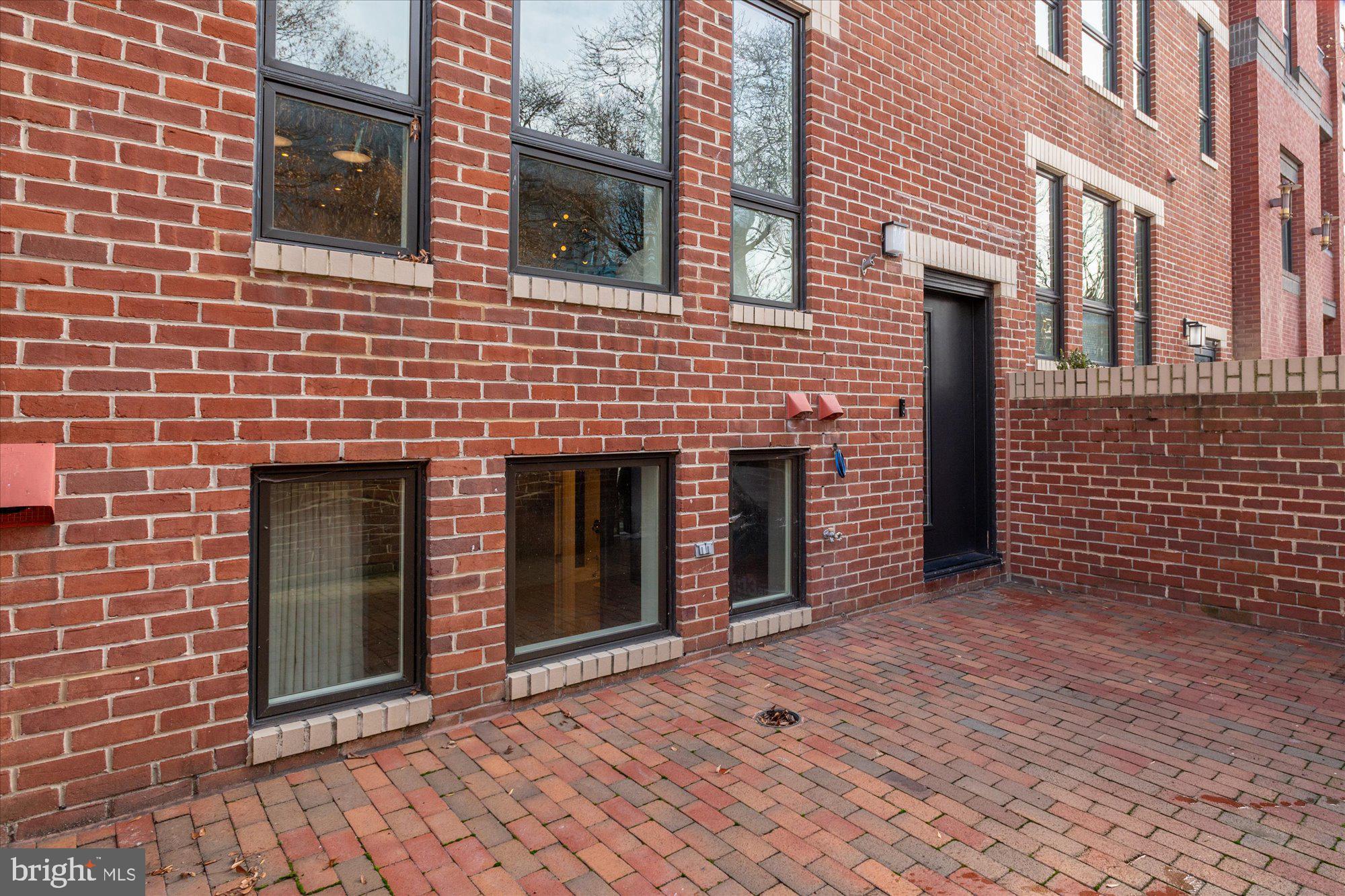 7313 Woodmont Avenue, Unit R Bethesda, MD 20814 - Photo 29 of 29 a view of a brick house with an outdoor space