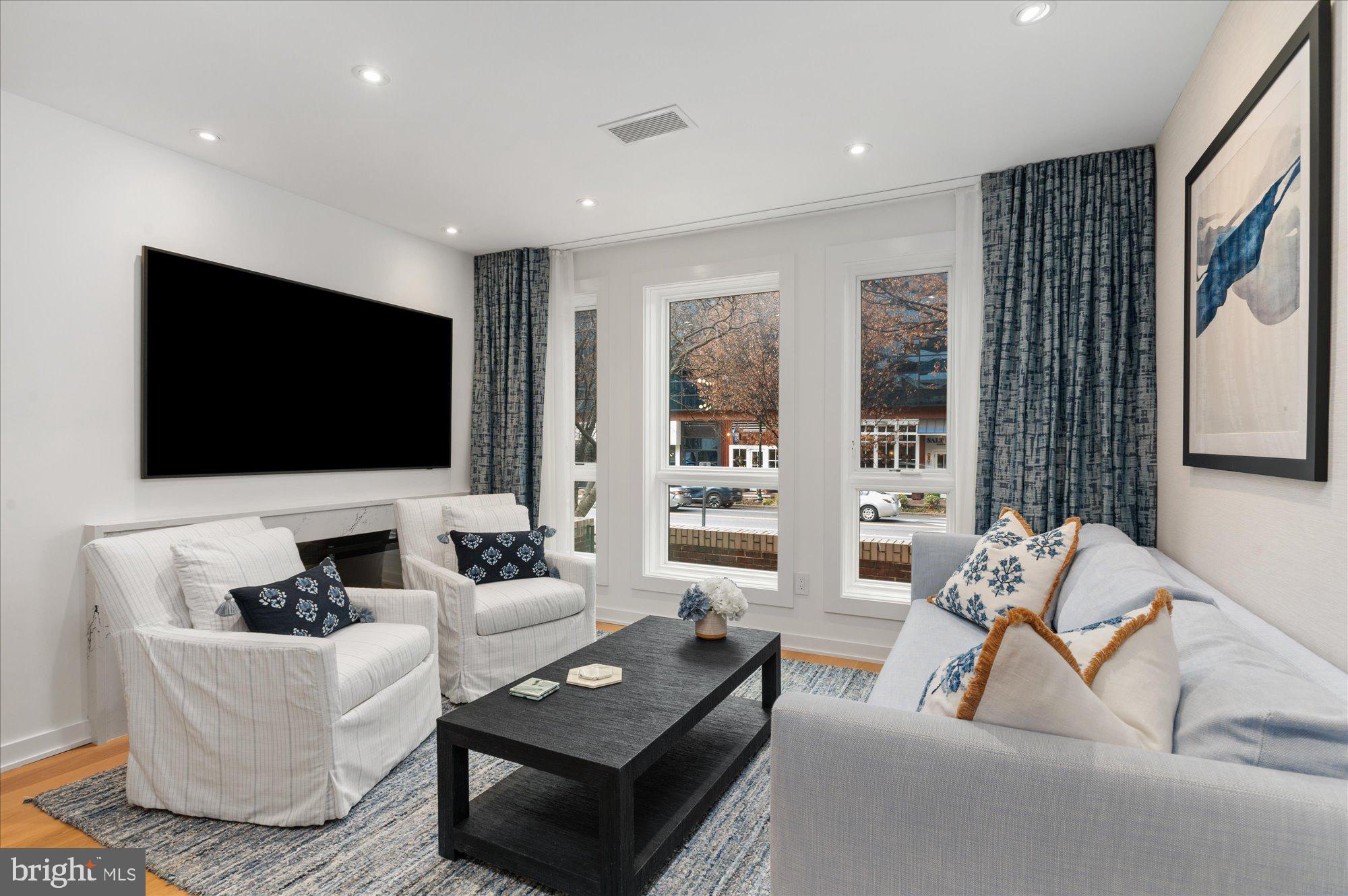 7313 Woodmont Avenue, Unit R Bethesda, MD 20814 - Photo 6 of 29 a living room with furniture and a flat screen tv