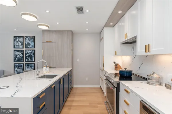 a kitchen with a sink stove and cabinets