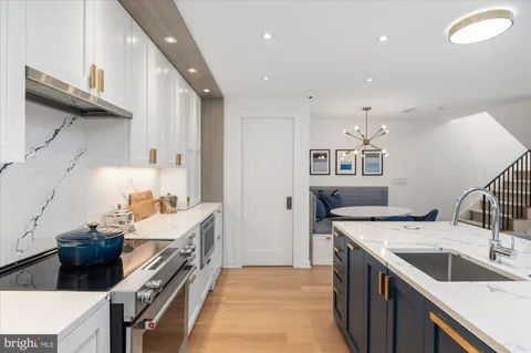 a kitchen with a sink stove and cabinets