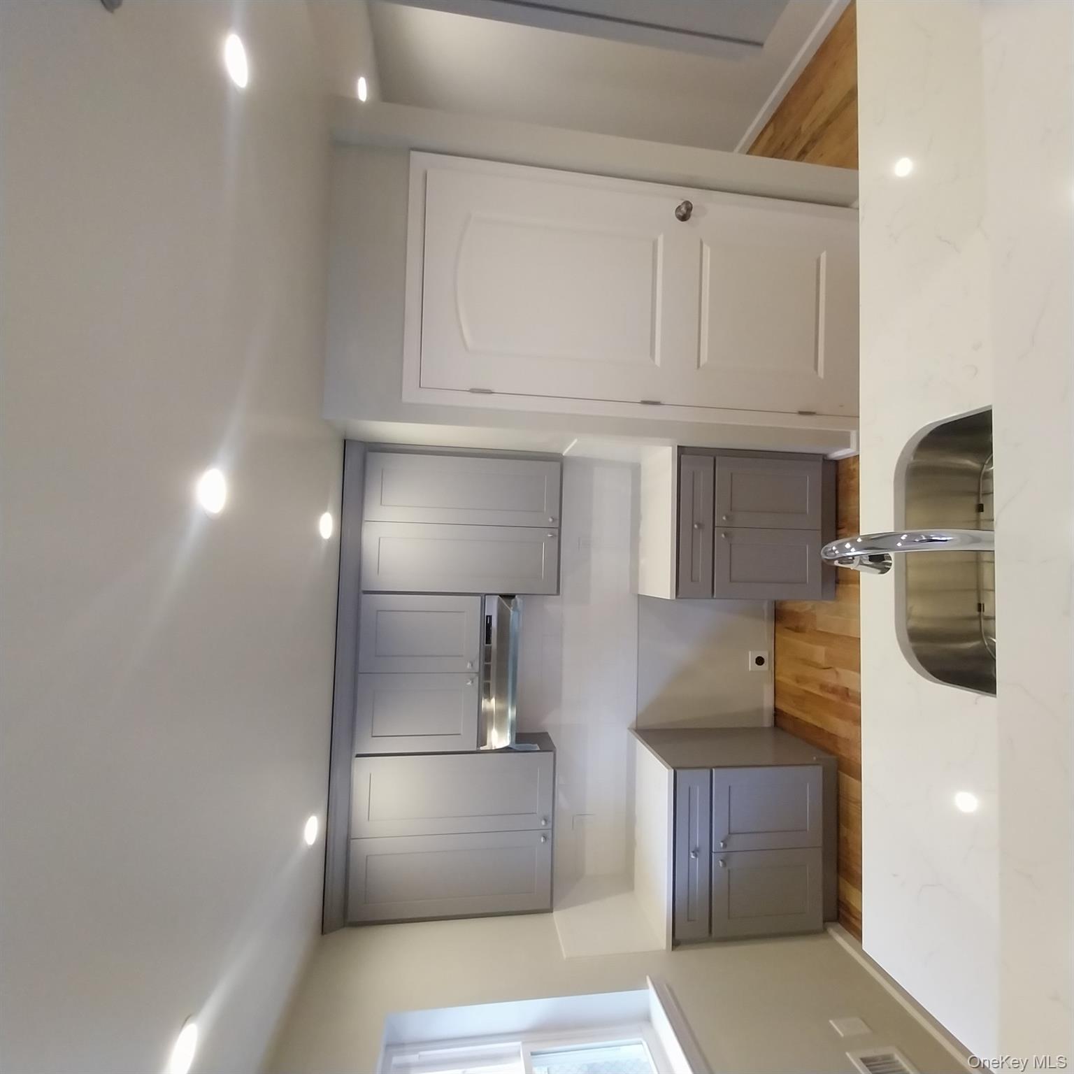 343 Jackson Street, Unit 1 Hempstead, NY 11550 - Photo 11 of 31 a kitchen with a sink and a refrigerator