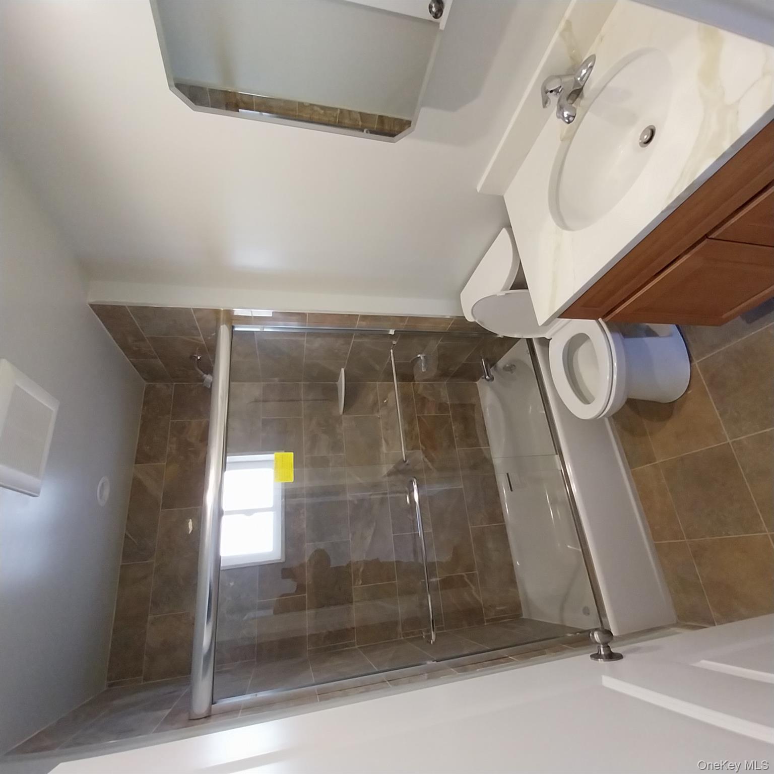 343 Jackson Street, Unit 1 Hempstead, NY 11550 - Photo 17 of 31 a bathroom with a sink toilet and shower