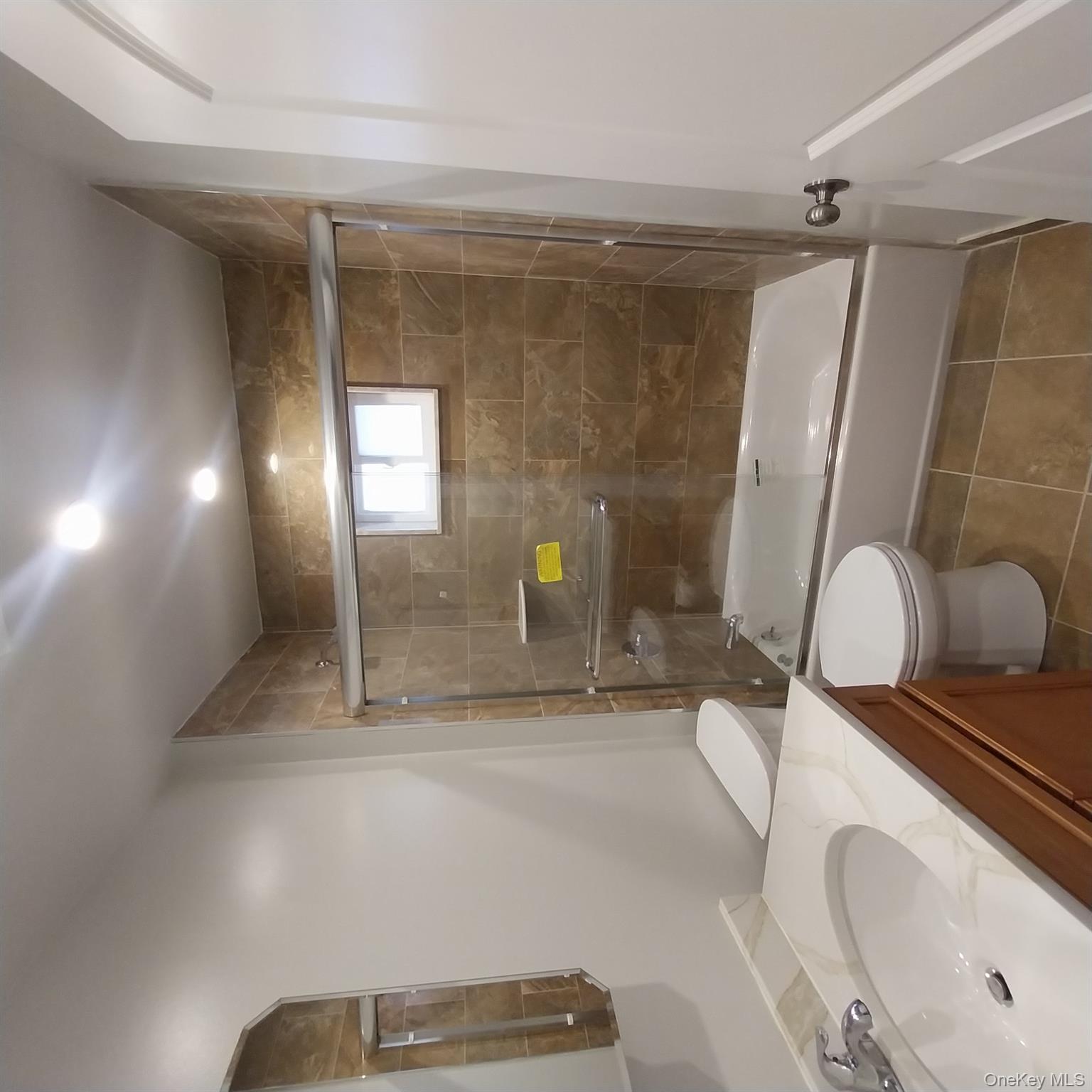 343 Jackson Street, Unit 1 Hempstead, NY 11550 - Photo 18 of 31 a bathroom with a sink mirror toilet and bathtub