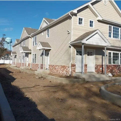 a view of a white house with a yard