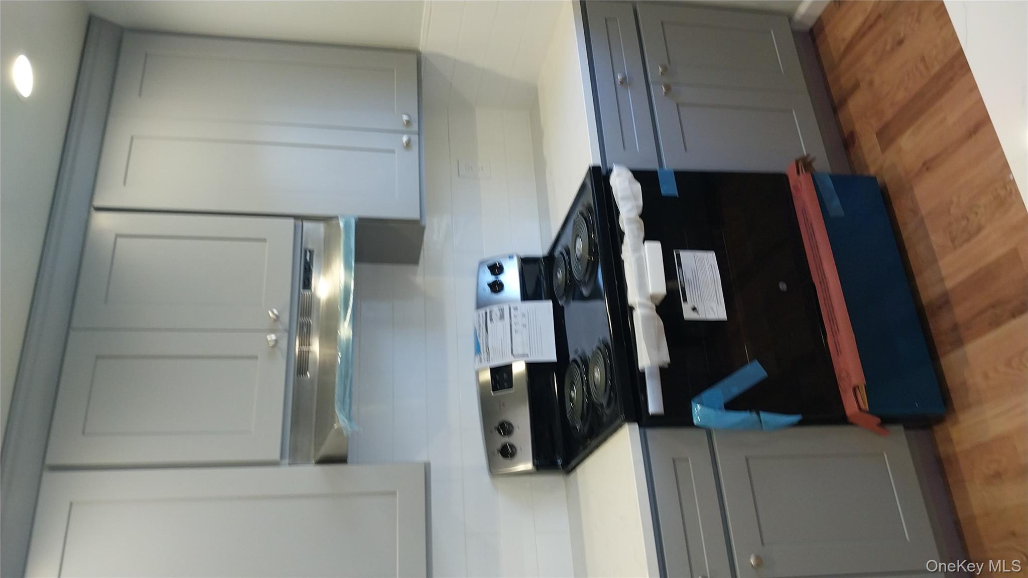 343 Jackson Street, Unit 1 Hempstead, NY 11550 - Photo 21 of 31 a stove top oven sitting inside of a kitchen