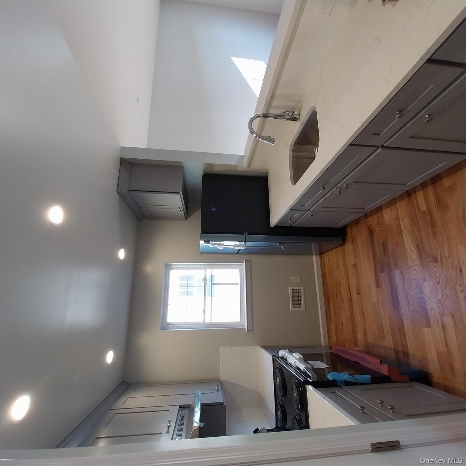343 Jackson Street, Unit 1 Hempstead, NY 11550 - Photo 24 of 31 a kitchen that has a sink and a stove top oven