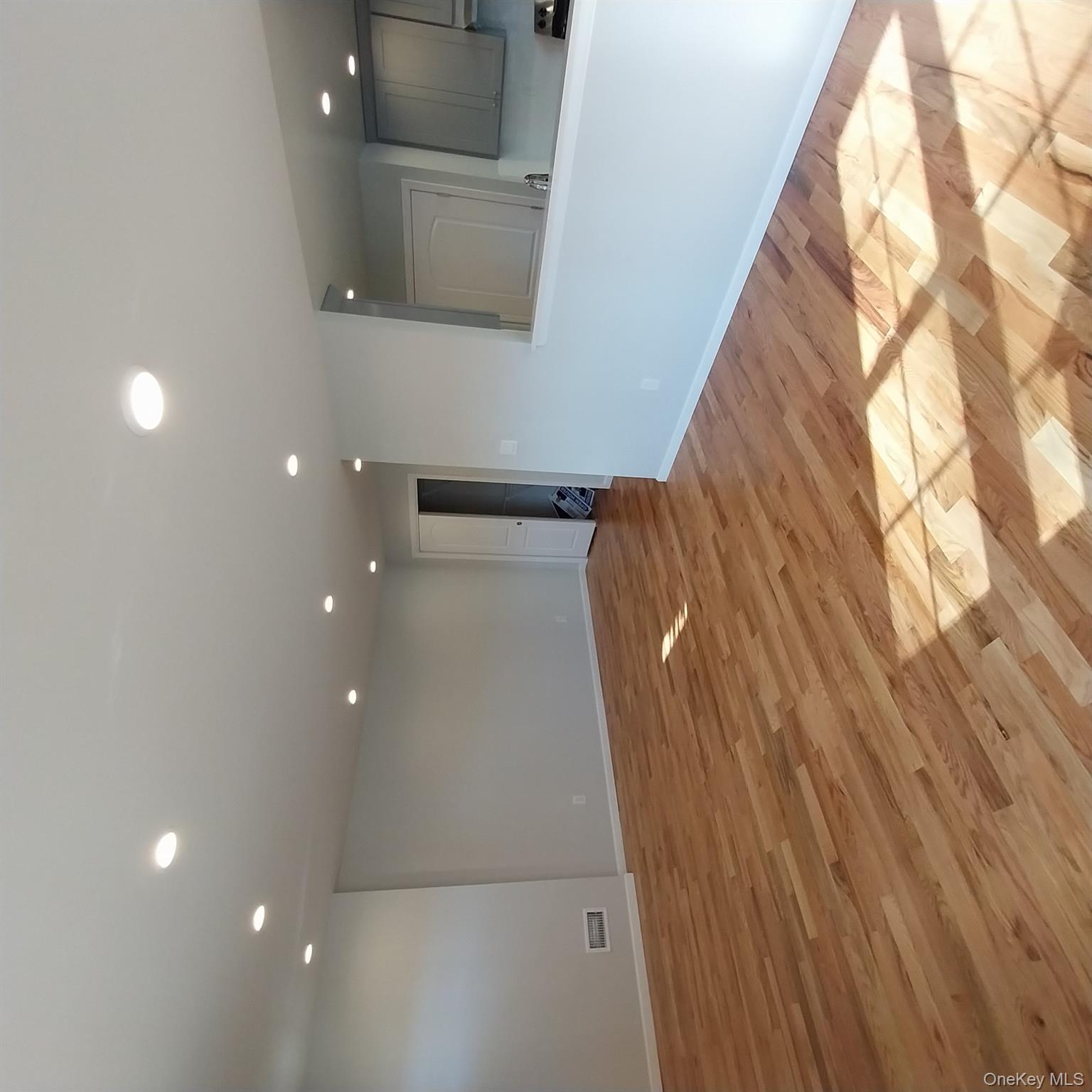 343 Jackson Street, Unit 1 Hempstead, NY 11550 - Photo 27 of 31 a view of an empty room with wooden floor