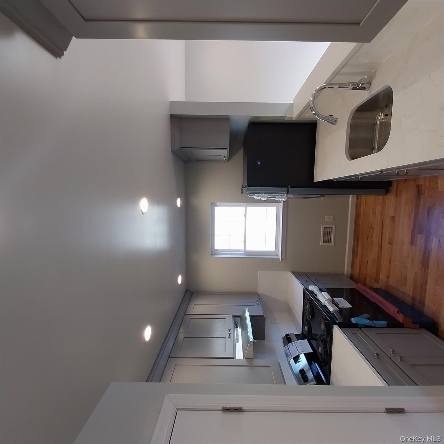 343 Jackson Street, Unit 1 Hempstead, NY 11550 - Photo 30 of 31 a kitchen with granite countertop a sink stove and refrigerator