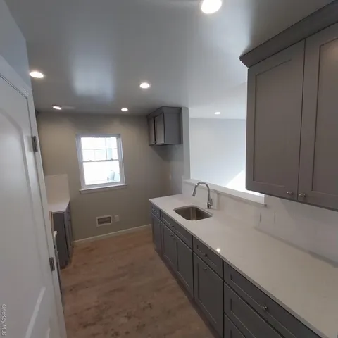 a kitchen with sink refrigerator and window