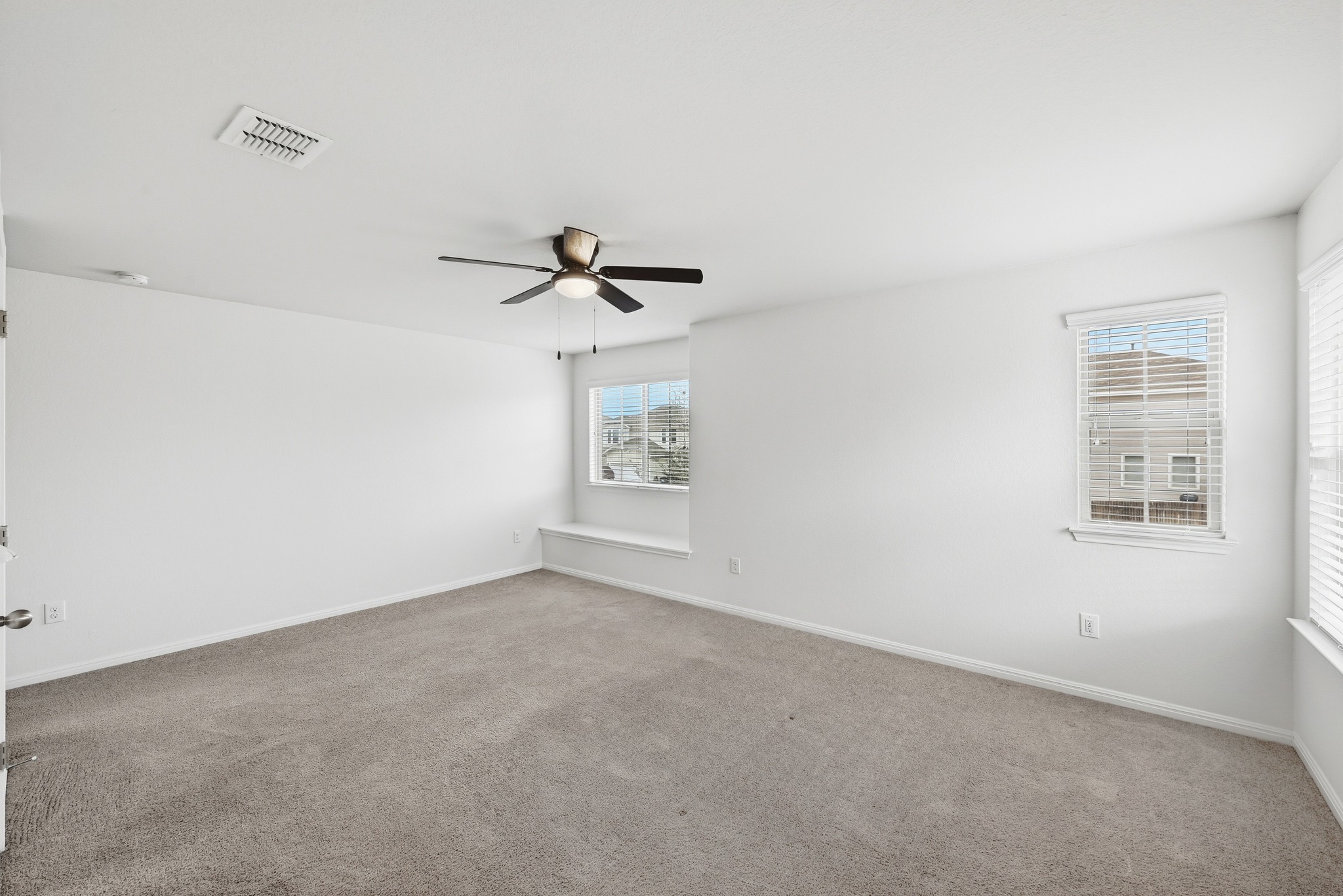 171 Vestral Road Buda, TX 78610 - Photo 17 of 26 Primary bedroom, located upstairs, with built- in window seat, walk in closet, and ensuite bath