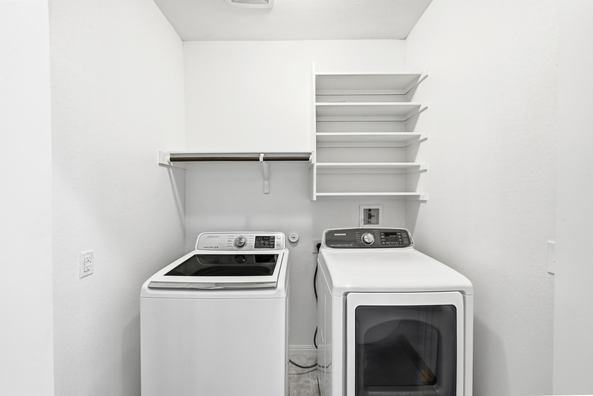 171 Vestral Road Buda, TX 78610 - Photo 23 of 26 Laundry room with washer and dryer; Additional hanging space and shelves for storage!