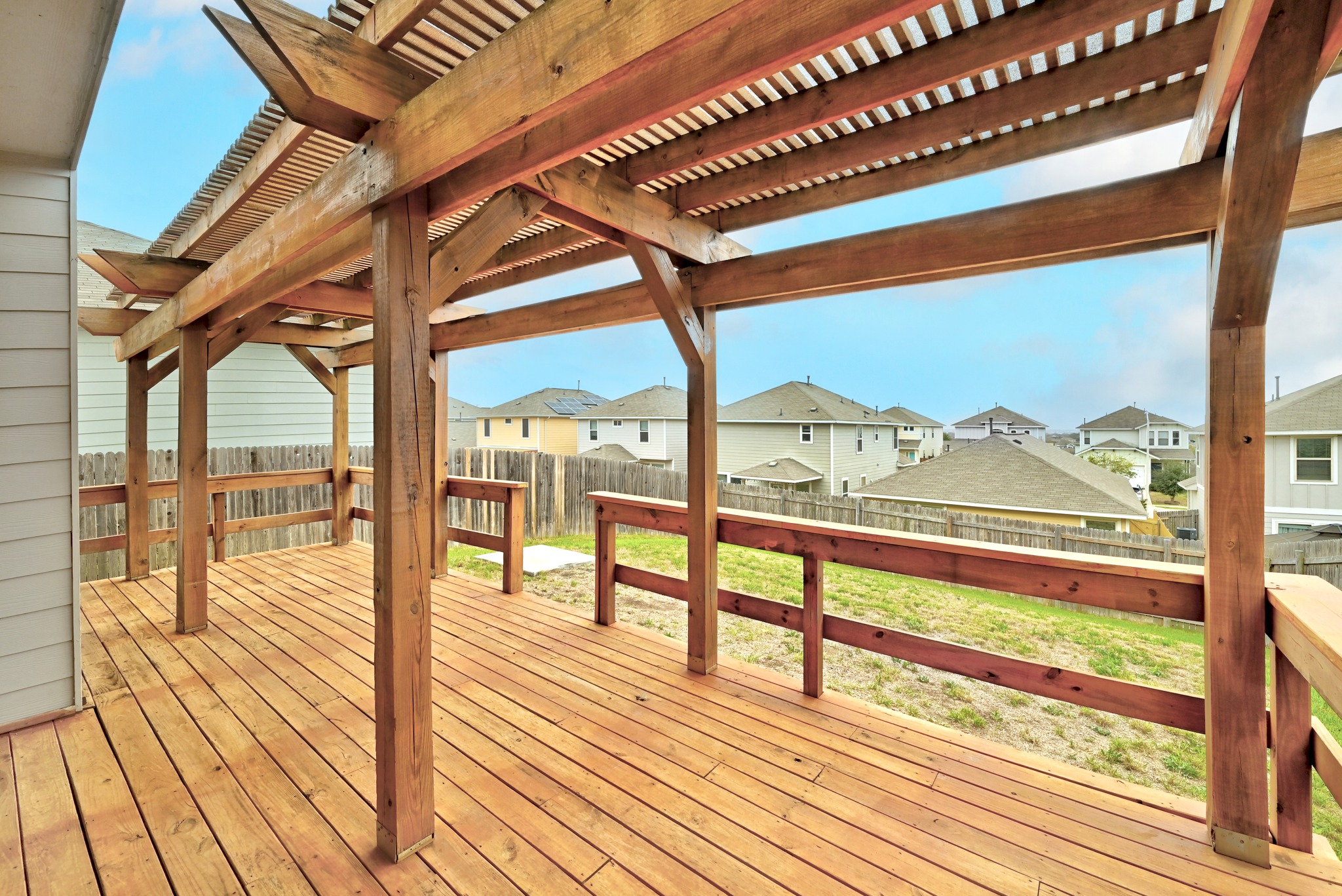 171 Vestral Road Buda, TX 78610 - Photo 25 of 26 Wooden deck featuring an arbor, and fenced backyard
