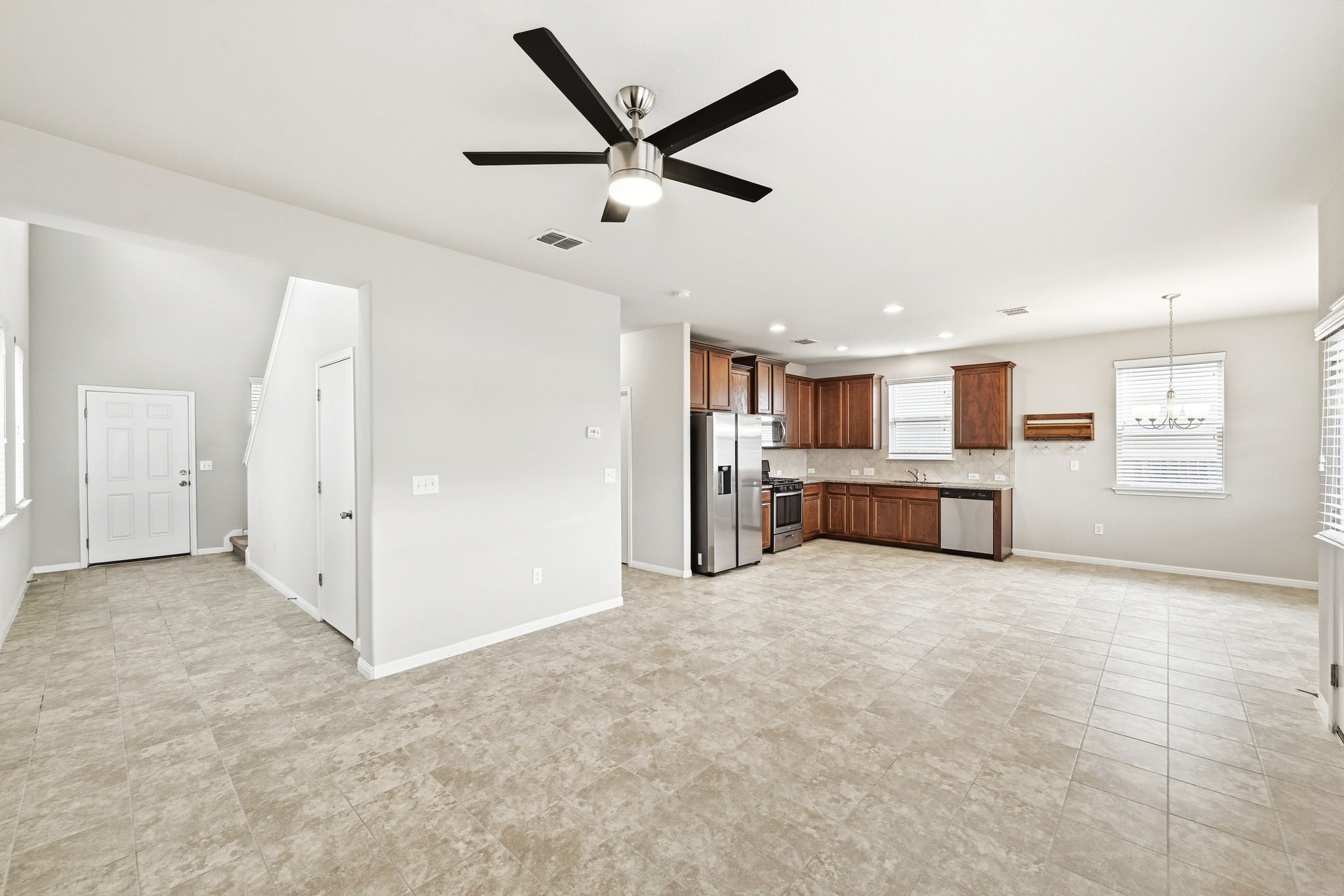 171 Vestral Road Buda, TX 78610 - Photo 6 of 26 Family room with a ceiling fan and ceramic tile flooring