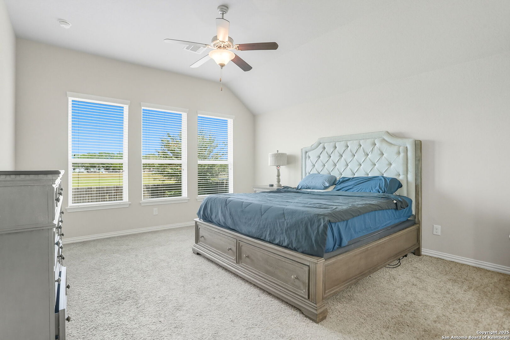 9825 Jon Boat Way Boerne, TX 78006 - Photo 14 of 25 a bed sitting in a spacious bedroom next to a window