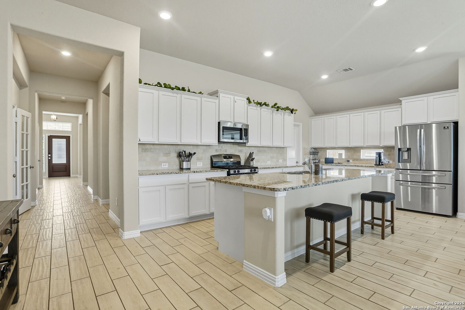 9825 Jon Boat Way Boerne, TX 78006 - Photo 6 of 25 a kitchen with cabinets and chairs