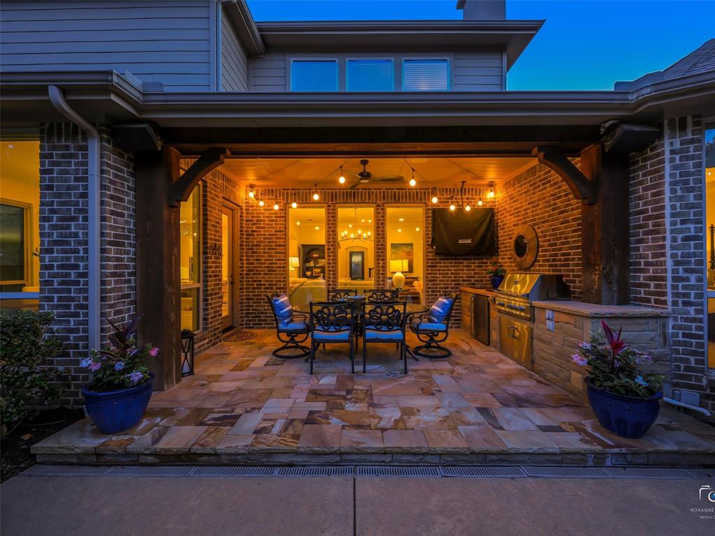 3117 Callander The Colony, TX 75056 - Photo 6 of 40 Pergola has built in heater for year around use. Resort like backyard with LARGE grassy area covered pergola, firepit and pool with sundeck and rain curtain.