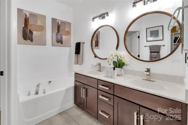 a bathroom with a double vanity sink and a mirror