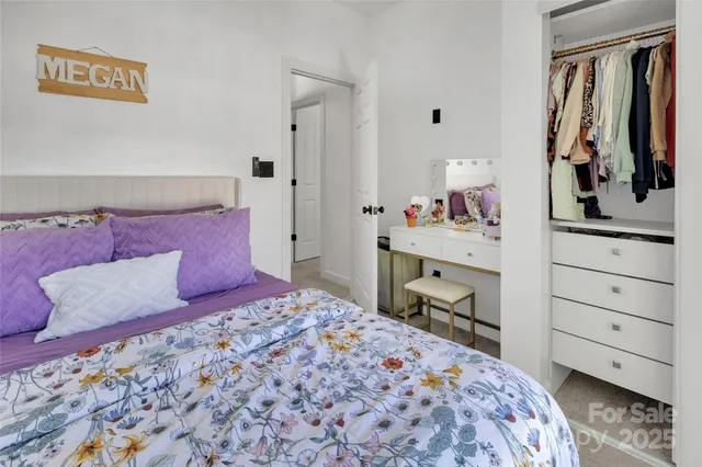 a bedroom with a bed and a dresser in it