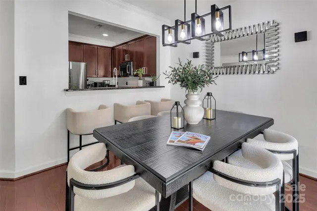 a view of a dining room with furniture and chandelier