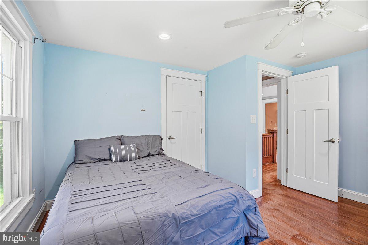 16146 Thomas Road Piney Point, MD 20674 - Photo 47 of 70 a bedroom with a large bed and wooden floor