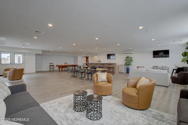 a kitchen with stainless steel appliances a stove a sink a microwave a refrigerator and cabinets