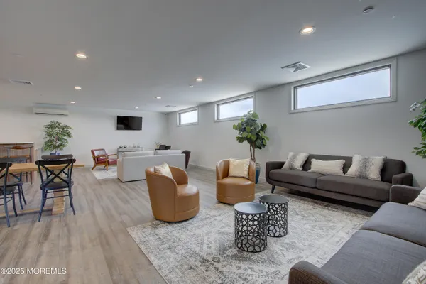 a living room with furniture and a floor to ceiling window