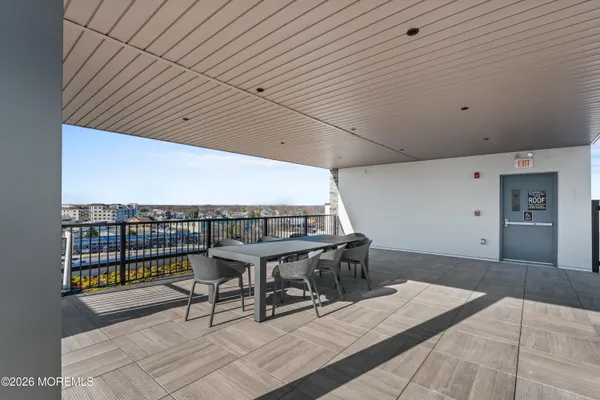 a roof deck with a table and chairs