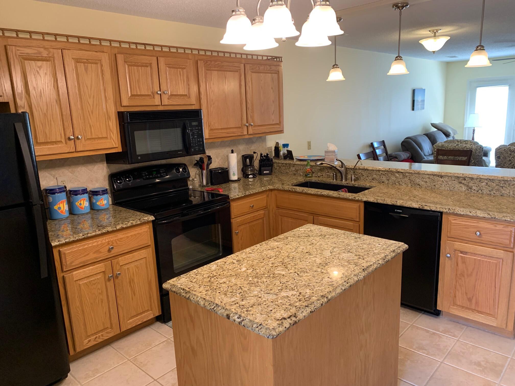 610 Monte Vista Road, Unit 706 Union Hall, VA 24176 - Photo 7 of 25 a kitchen with kitchen island granite countertop a sink counter top space appliances and cabinets